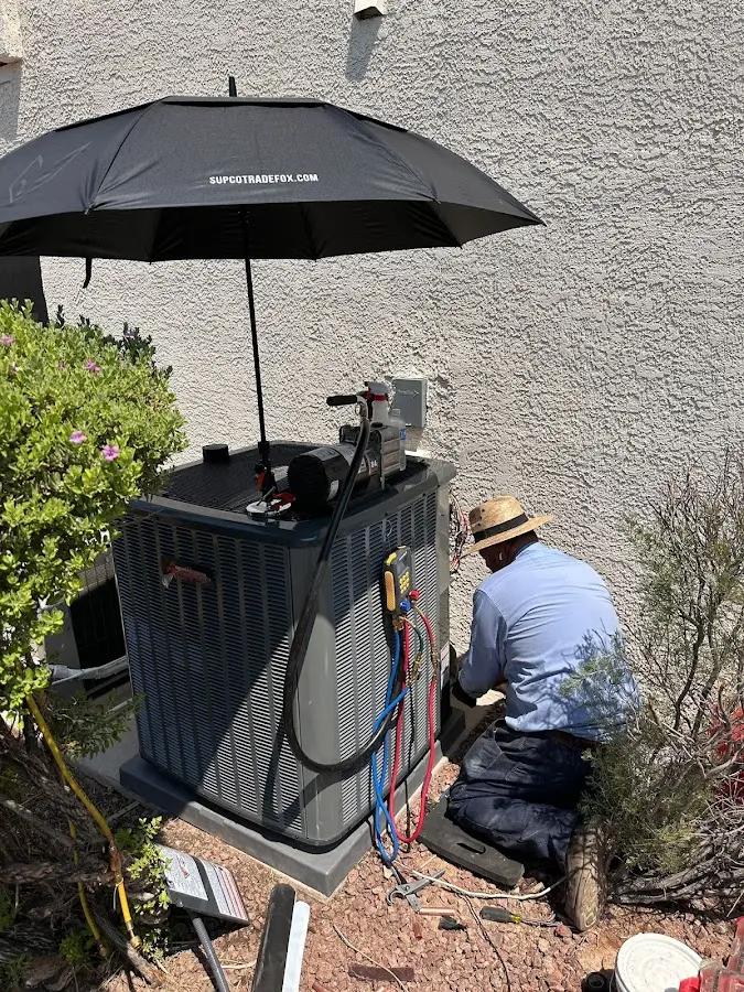 HVAC technician performing outdoor AC maintenance in Chadron